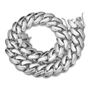 Detailed shot of silver chunky cuban link chain necklace, polished metallic texture closeup.