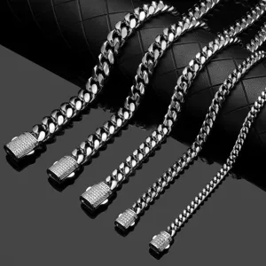 Detailed shot of men's stainless steel Cuban link chain necklace with iced out pave clasp.