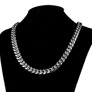 Detailed close-up of silver Cuban link chain showing polished metal texture and link details.