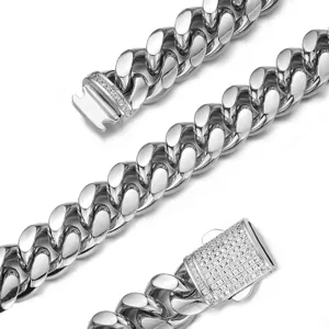 Close-up detail of stainless steel Cuban link chain with paved rhinestone clasp, silver tone.