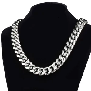 Thick silver stainless steel Cuban link necklace detail, heavy metal chain close-up jewelry showcase.