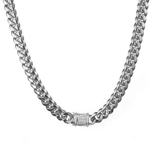 Close-up detail of silver Miami Cuban link necklace with pave diamond clasp, metal texture.