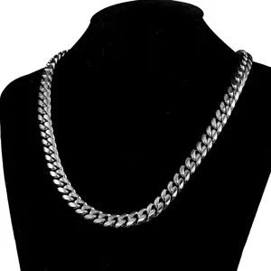 Close-up detail of the chunky silver Cuban link necklace showing polished metal links.