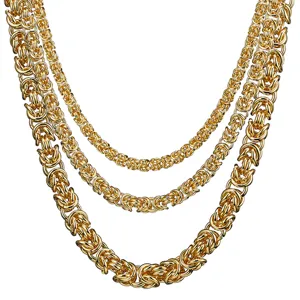 Detailed close-up of layered gold Byzantine chains, stainless steel men's necklace.