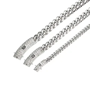 Close-up detail of silver stainless steel Cuban link chains featuring iced-out zircon clasps.