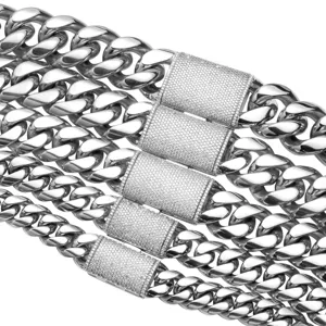 Stainless steel Cuban link chain detail, iced out cubic zirconia lock clasp, hip hop jewelry style.