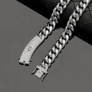 Men's iced out Cuban link chain necklace with cubic zirconia clasp and stainless steel finish.