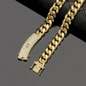 Gold stainless steel Cuban chain detail closeup, featuring iced zircon clasp and letter S logo.