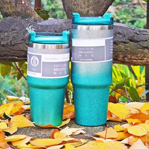 Glitter finish vacuum insulated stainless steel tumblers on a bed of autumn leaves