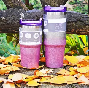 Two purple glitter vacuum insulated mugs in 30oz and smaller size on autumn leaves.