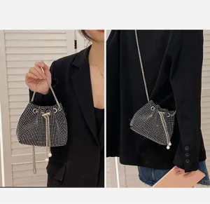 Stylish black rhinestone drawstring bucket bag shown in handheld and crossbody modes.