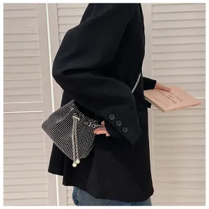 Sparkly black rhinestone drawstring bucket bag for women, styled with a black blazer.