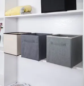 Set of grey and beige foldable non-woven fabric storage bins on a white shelf