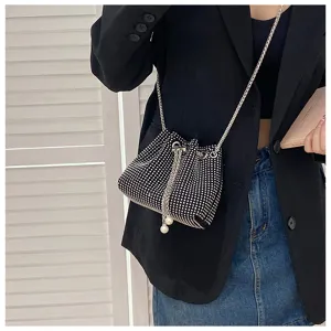 Detailed view of sparkling rhinestone drawstring bucket bag with elegant pearl charms