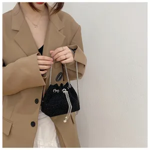 Detailed close-up showing the sparkling black rhinestone surface of the evening bucket bag