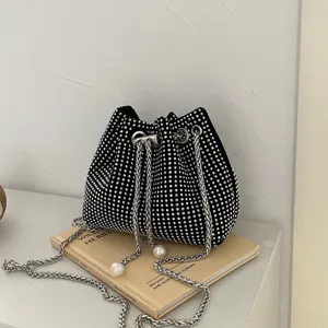 Elegant black drawstring bucket bag with silver rhinestones and pearl chain strap
