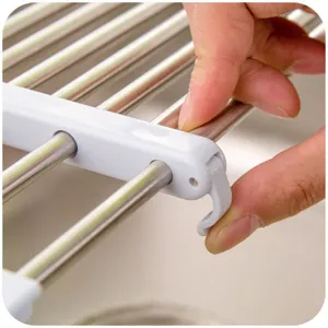 Escurridor de fregadero telescópico de acero inoxidable, organizador de cocina ajustable.
