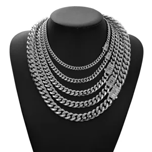 Detailed shot of layered stainless steel Cuban link chains with crystal lock for men.