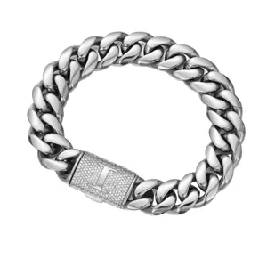 Detail shot of steel color Cuban chain necklace with pavé letter T clasp for men.