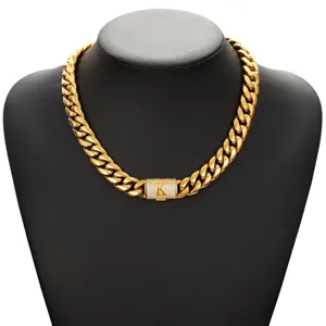 Gold Cuban link chain necklace featuring a pave diamond letter K flip clasp detail view.