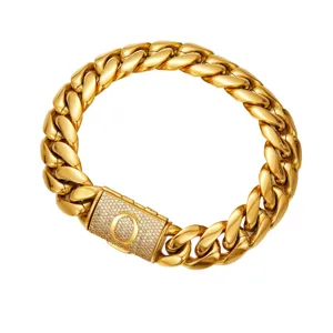 Close-up detail of a gold Cuban link chain necklace with a paved rhinestone letter O lock clasp.