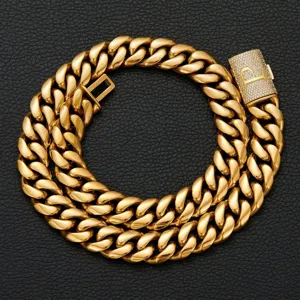 Close-up of gold Cuban link chain necklace with paved diamond initial P clasp detail.