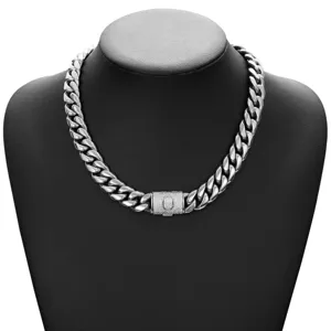 Close-up detail of silver Cuban link chain necklace with iced out flip clasp for men.