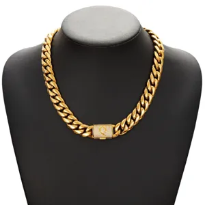 Detail view of gold hip hop cuban chain necklace with diamond letter clasp for men.