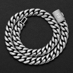 Detailed view of men hip hop stainless steel cuban link chain with letter Q pave clasp.
