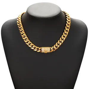 Detailed view of the gold cuban link chain necklace with iced out letter U clasp.
