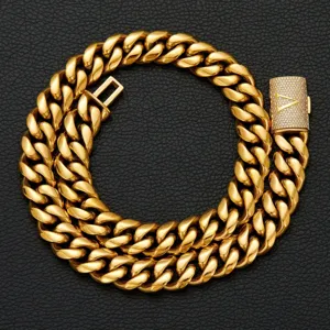 Detailed close-up of mens gold hip hop cuban link chain featuring rhinestone pave clasp with letter V.