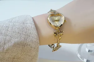 Gold heart-shaped quartz watch detail showcasing rhinestone dial and elegant bow bracelet.