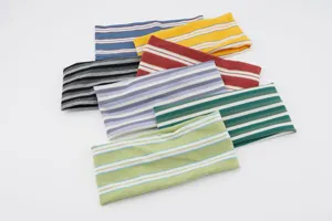 Detailed view of colorful striped knitted elastic headbands, soft fabric for yoga and sports wear.