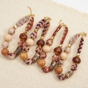 Bohemian Maillard style fabric beaded necklace with gradient resin beads and gold.