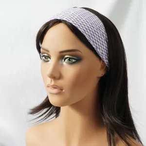 Detail view of the purple and white woven elastic headband worn on a mannequin head.