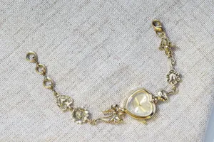 Vintage gold heart bracelet watch with bow and floral charms, stylish quartz women watch.