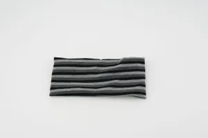 Close-up detail showing the black and grey striped texture of the elastic knitted headband.