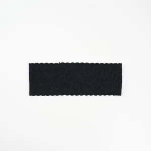 Black lace headband detail showing floral wavy edge and high elasticity fabric texture.