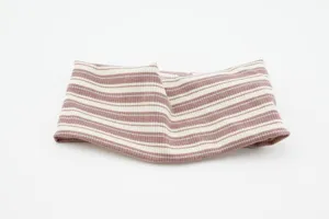 Detailed shot of knitted striped headband, soft ribbed texture, flexible wide hair accessory.