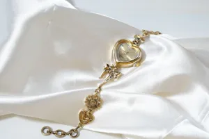 Vintage gold heart bracelet watch with bow and flower charms, elegant fashion quartz women watch