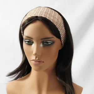Close-up view of a stylish brown and white checkered elastic hairband, showing textured fabric details.