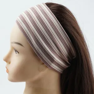 Detailed view of the wide striped knitted headband, elastic retro yoga hair band in brown.