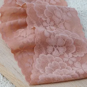 Detailed view of the wide elastic floral lace trim headband, featuring a retro wavy edge.