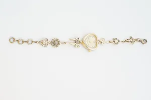Vintage gold heart charm watch with floral and bow accents, elegant quartz wrist watch for women.