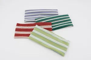 Close-up detail of soft striped knit elastic headbands, showing colorful ribbed texture.
