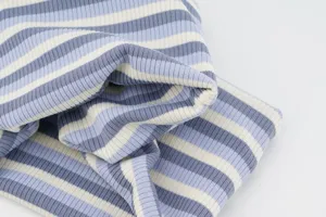 Close-up of blue and white striped elastic knit fabric detail, soft texture and flexible wear.