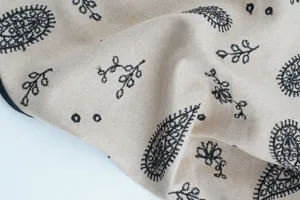 Close-up detail of vintage ethnic cotton paisley and floral embroidered bandana fabric.