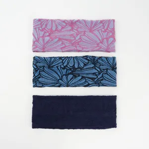 Detailed view of wide stretch cotton headbands featuring floral patterns in three colors.