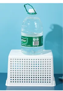 White plastic mesh storage basket detail showing high load capacity with large water bottle.