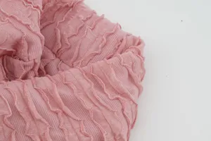 Pink crinkled knit fabric detail, stretchy pleated texture with ruffle edge for headband.